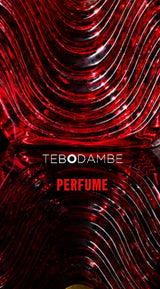 Close-up of the sculptural, wavy red glass bottle designed for TEBO DAMBE® Fleur Noir fragrance.