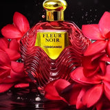 Red Fleur Noir perfume bottle on water against a dark background, surrounded by red flowers.