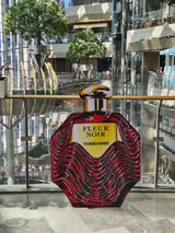 Oversized red Fleur Noir perfume bottle showcasing the sculptural bottle design by Tebo Dambe.